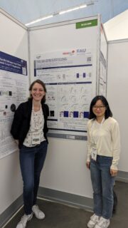 Jingna Qiu (r) and Katharina Breininger (l) in front of the MICCAI Poster on Adaptive Region Selection.